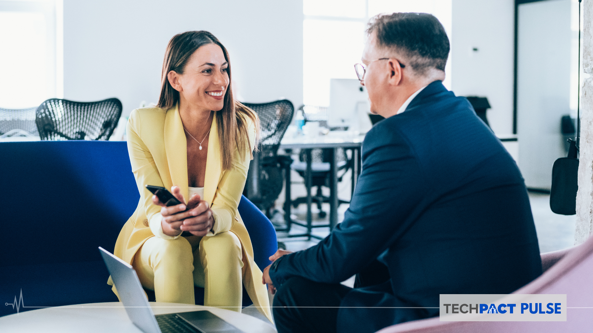 A man and a woman having a conversation in a professional setting