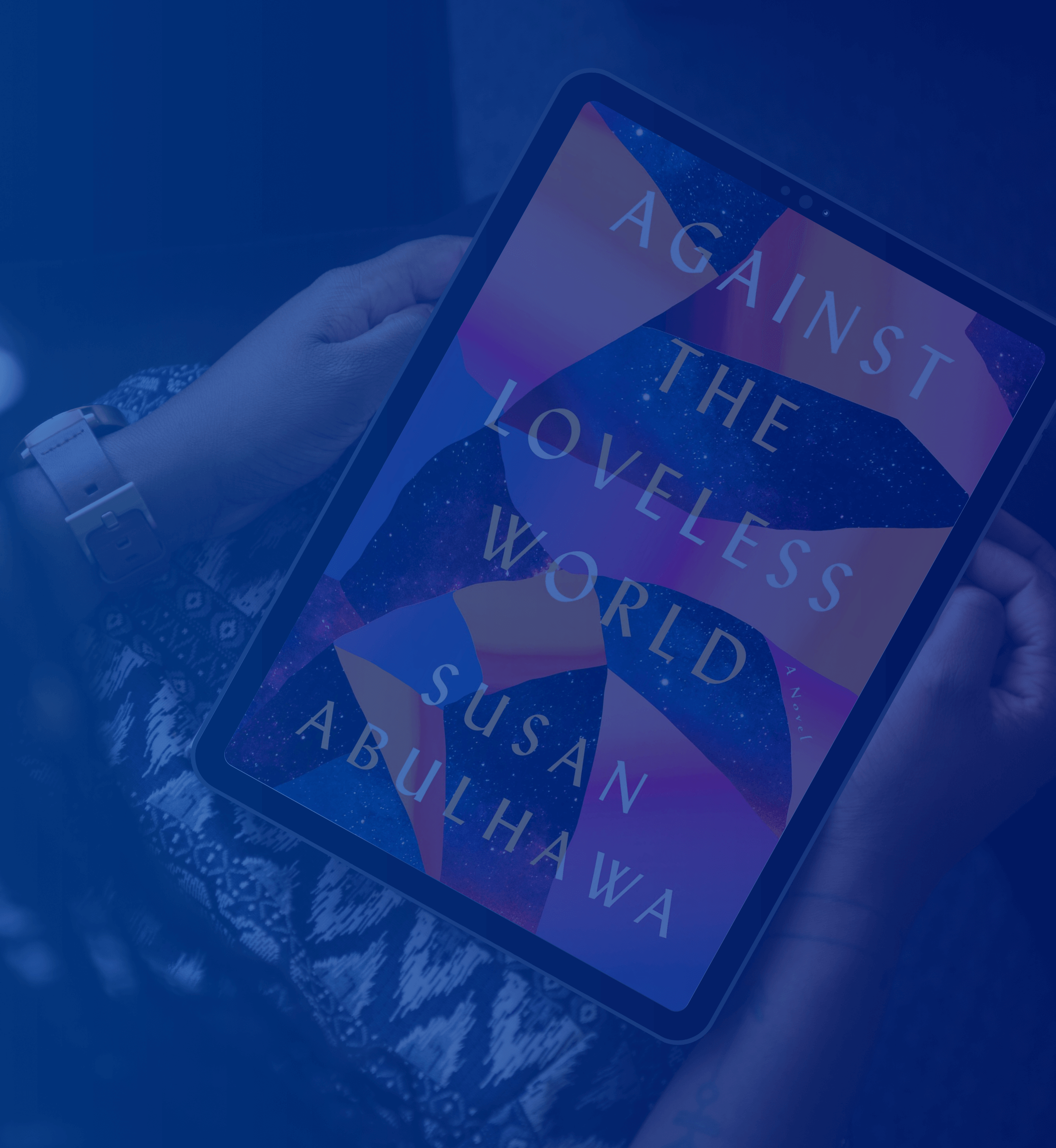 A lady holding a tablet with the cover of the book Against The Loveless World by Susan Abulhawa