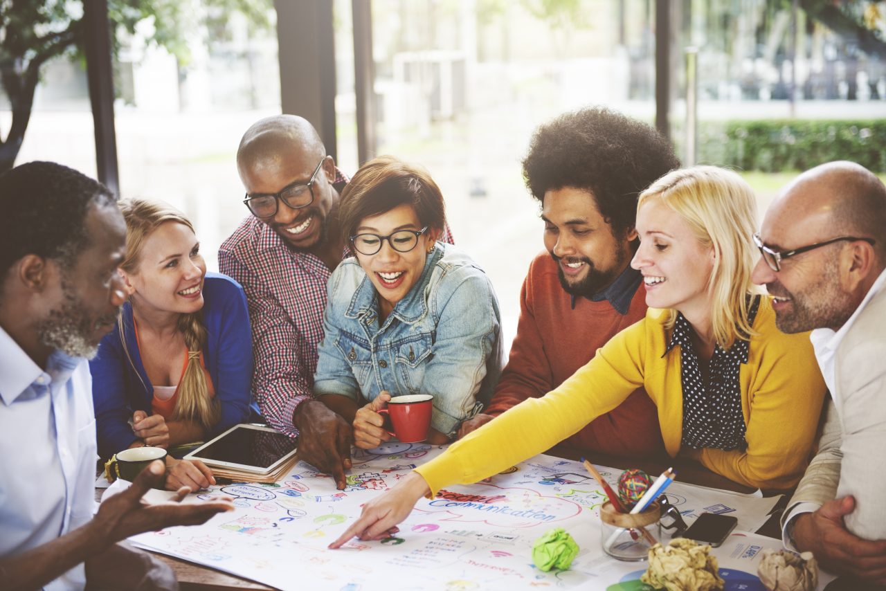 Group of people reviewing a poster