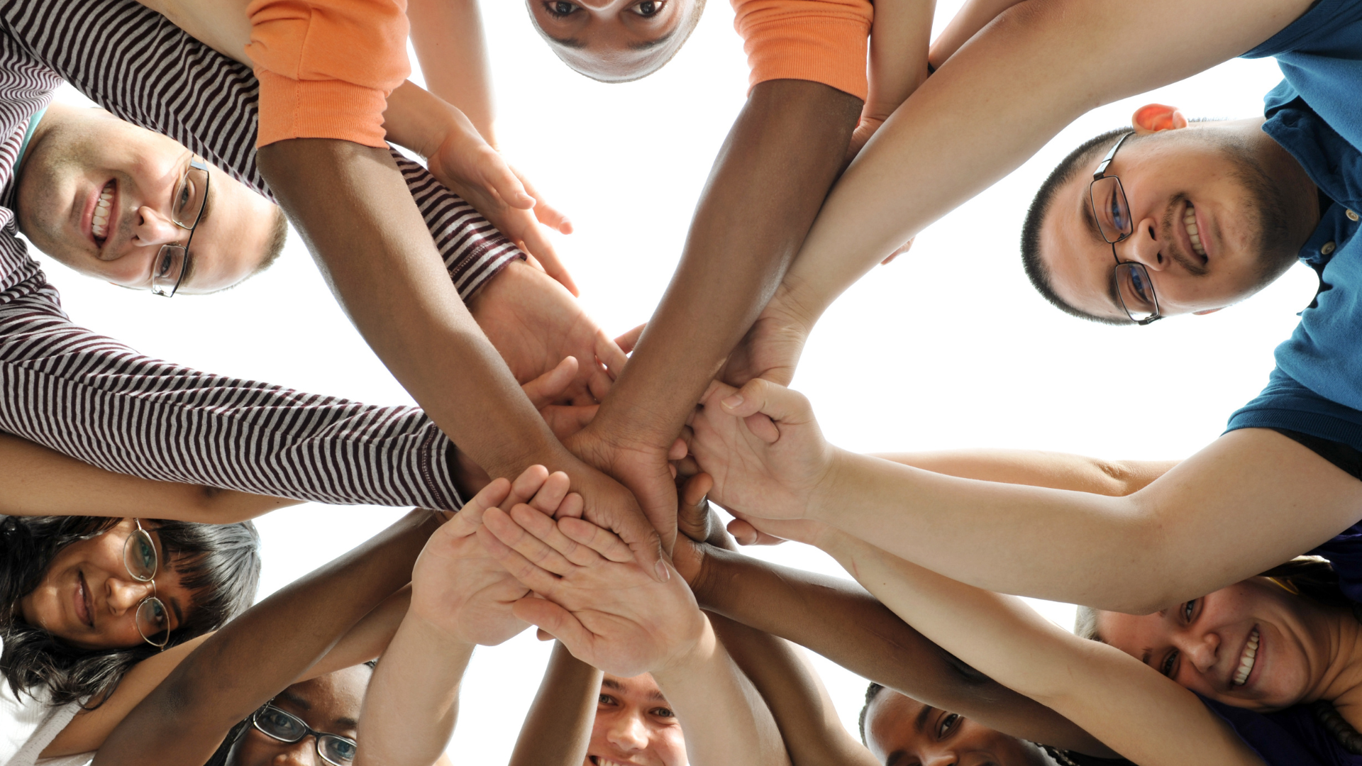 An image of people's faces and hands displaying collaboration